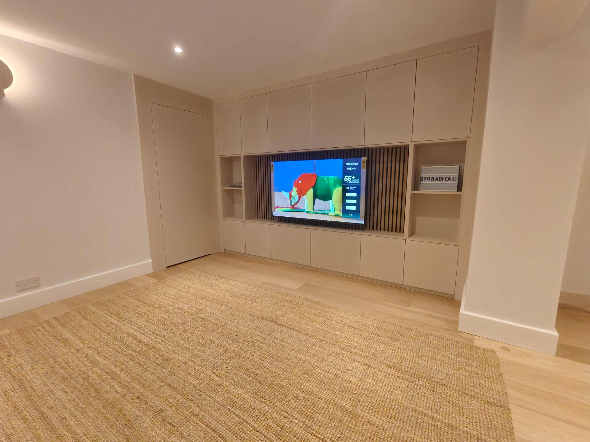 Built-in media wall with oak slat panelling