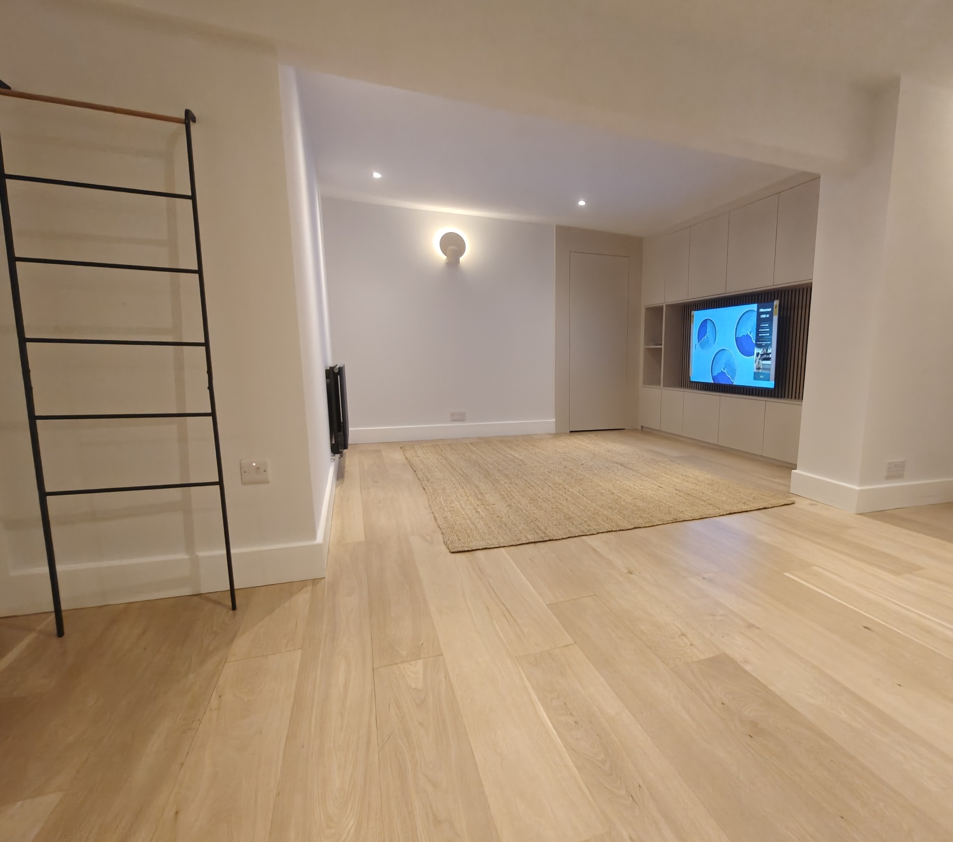 Open-plan living space with light oak flooring